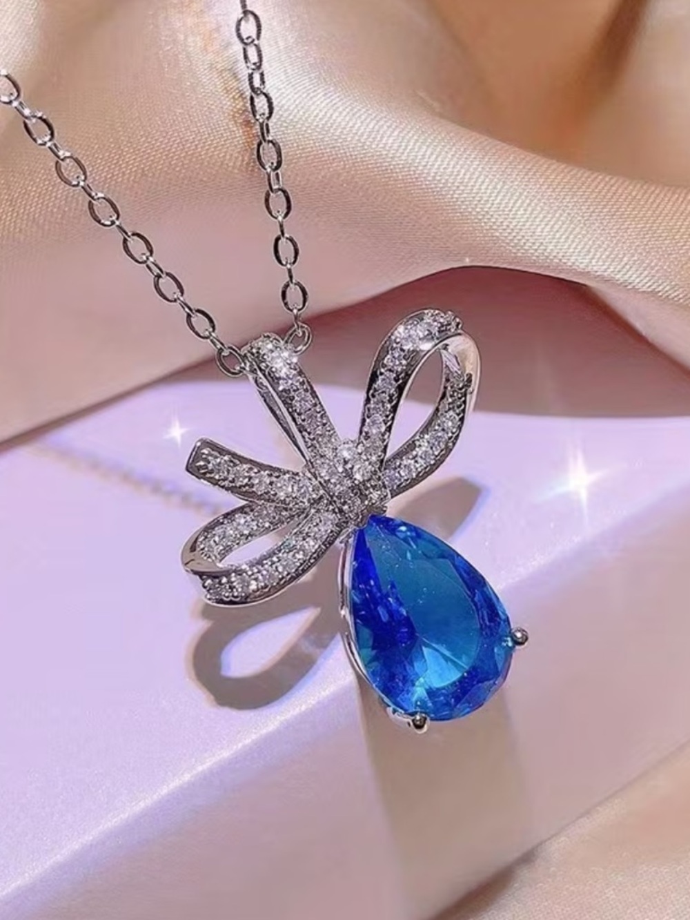 Silver Bow Necklace with Blue Teardrop Pendant